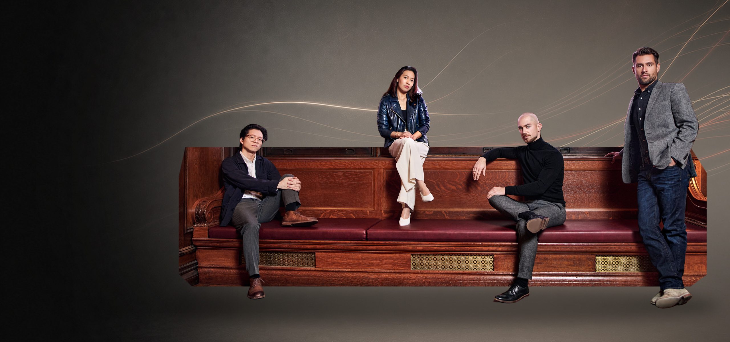 The Dover Quartet seated on a bench